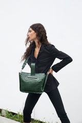 Crossbody handbag in forrest green croc embossed leather on model