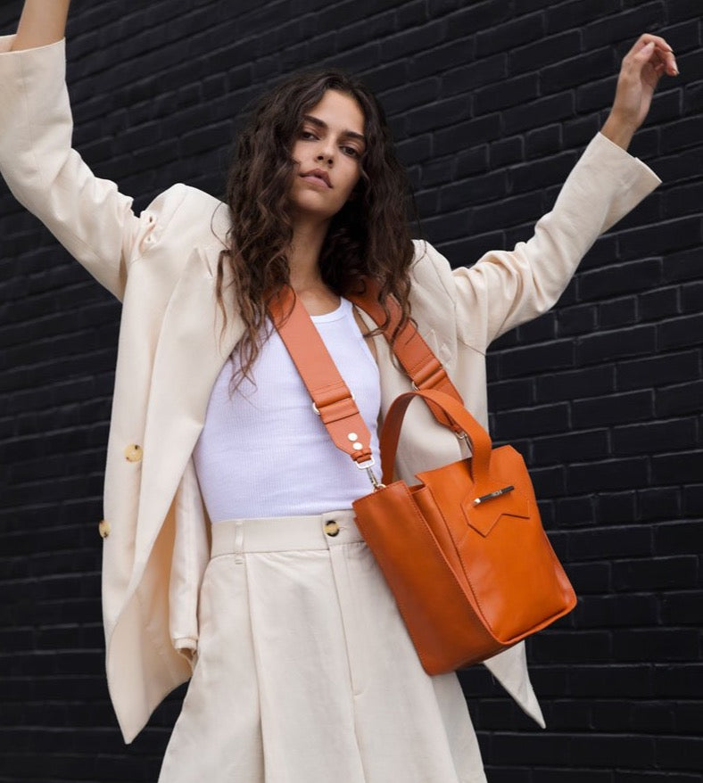 Crossbody handbag in orange croc embossed leather on model